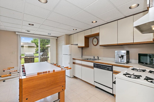 1642 Iowa Dr, Elk Grove Village, IL 60007 - kitchen featuring white appliances, exhaust hood, white cabinets, light countertops, and a paneled ceiling