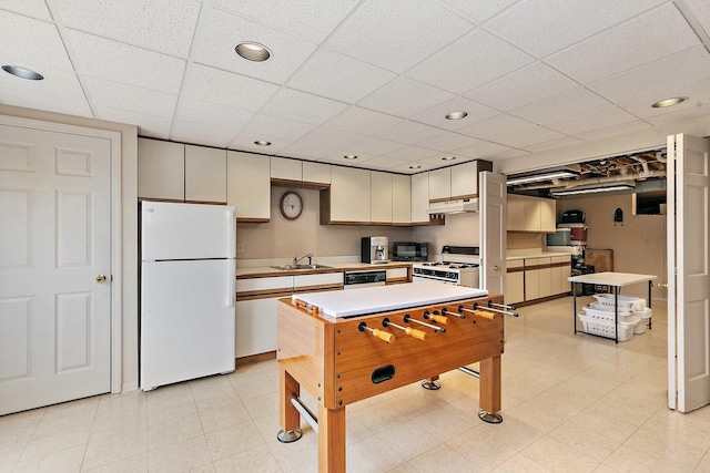 1642 Iowa Dr, Elk Grove Village, IL 60007 - kitchen featuring white appliances, under cabinet range hood, light countertops, a paneled ceiling, and white cabinetry