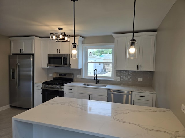 540 47th Ave, Bellwood, IL 60104 - kitchen featuring appliances with stainless steel finishes, decorative backsplash, white cabinetry, and hanging light fixtures