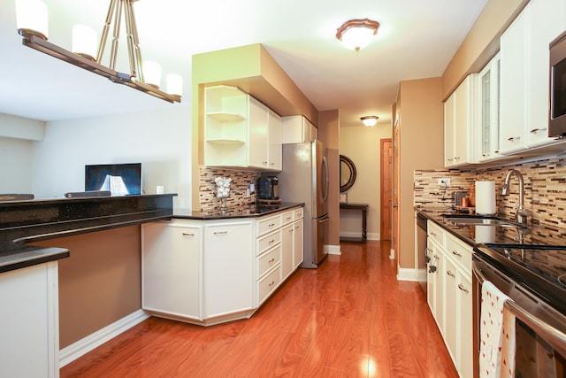 1415 E Central Rd Unit 219C, Arlington Heights, IL 60005 - kitchen featuring decorative backsplash, light wood-style floors, stainless steel appliances, and open shelves