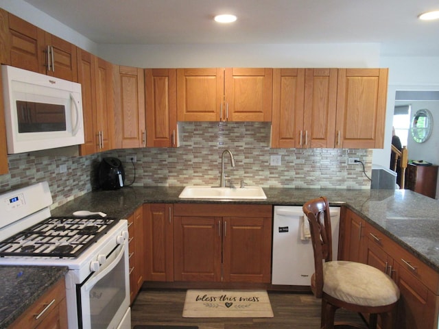 1819 Dunsford Ct, Schaumburg, IL 60194 - kitchen with white appliances, tasteful backsplash, dark stone counters, dark wood-style floors, and brown cabinets