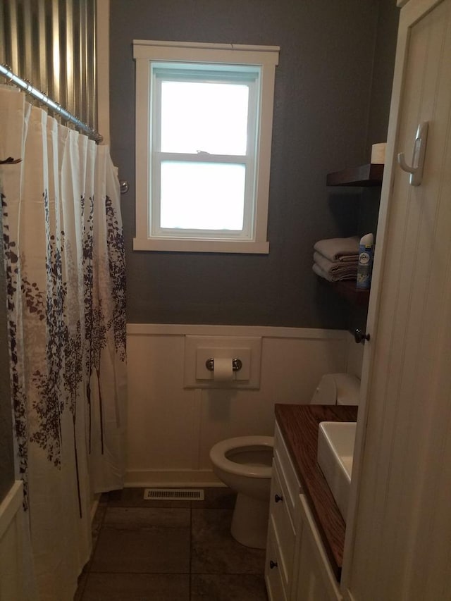 711 S 3rd St, Oregon, IL 61061 - full bathroom with a wainscoted wall, vanity, tile patterned floors, and a decorative wall