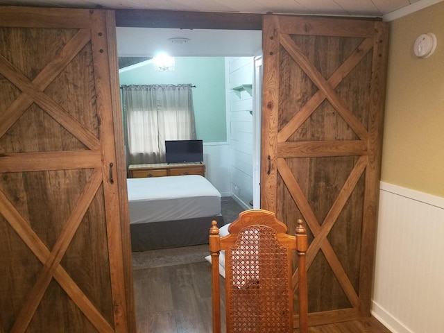711 S 3rd St, Oregon, IL 61061 - bedroom featuring a wainscoted wall and wood finished floors