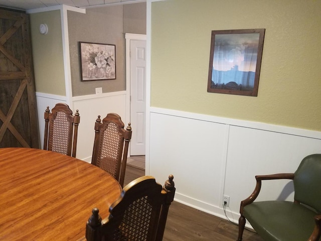 711 S 3rd St, Oregon, IL 61061 - dining area with dark wood-style floors, wainscoting, and a decorative wall