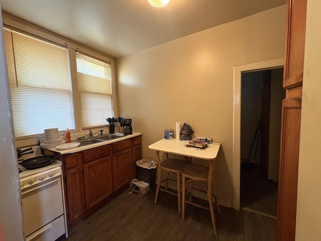 17 S Cagwin Ave, Joliet, IL 60436 - kitchen with white electric stove, dark wood-style floors, brown cabinets, light countertops, and a kitchen breakfast bar