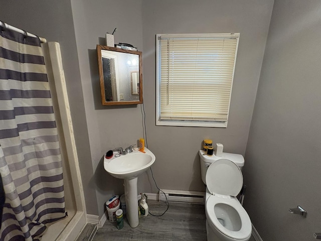 17 S Cagwin Ave, Joliet, IL 60436 - bathroom with baseboard heating, a shower with shower curtain, and wood finished floors