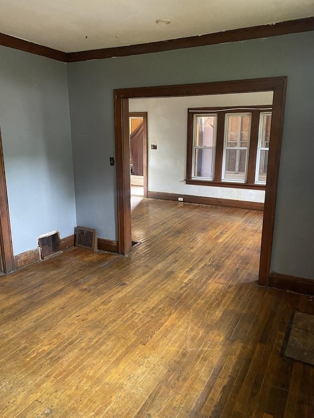 945 E Hickory St, Kankakee, IL 60901 - unfurnished room featuring wood-type flooring and crown molding
