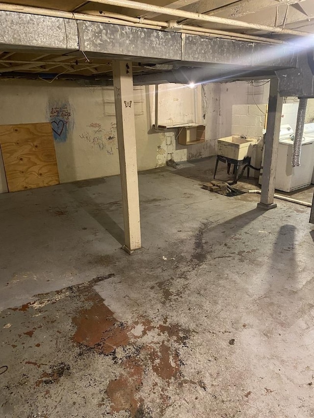 945 E Hickory St, Kankakee, IL 60901 - unfinished below grade area with washer / dryer and a sink
