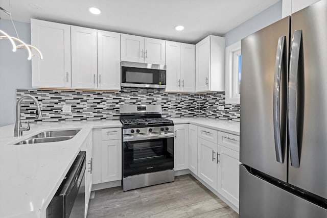 19400 Oak Ave Unit 1, Country Club Hills, IL 60478 - kitchen featuring stainless steel appliances, light wood finished floors, white cabinetry, recessed lighting, and decorative backsplash