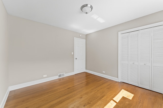 5008 Culver St, Skokie, IL 60077 - unfurnished bedroom with wood finished floors and a closet