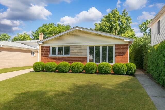 5008 Culver St, Skokie, IL 60077 - view of front facade featuring a front yard, brick siding, and a chimney
