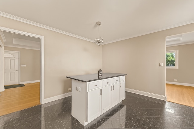 5008 Culver St, Skokie, IL 60077 - kitchen featuring granite tiled floors, dark countertops, crown molding, white cabinetry, and a center island