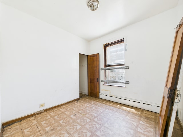 5045 W Erie St, Chicago, IL 60644 - unfurnished bedroom with baseboard heating and light flooring