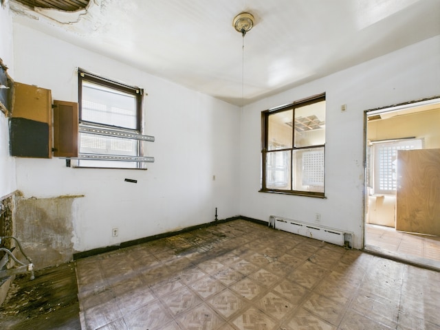 5045 W Erie St, Chicago, IL 60644 - unfurnished room featuring a baseboard heating unit