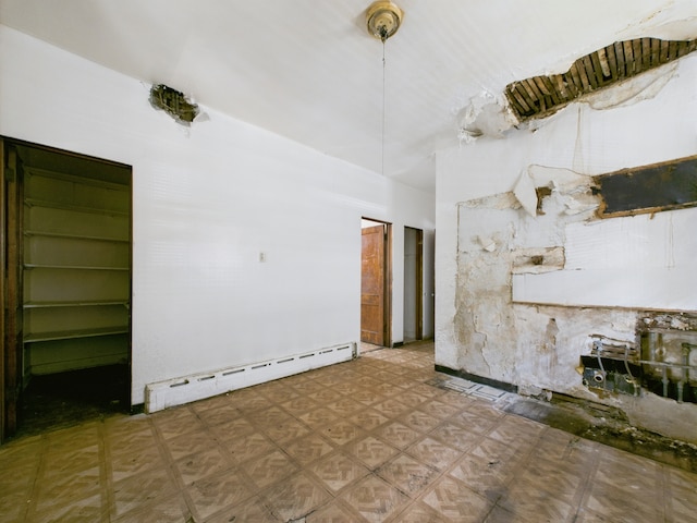 5045 W Erie St, Chicago, IL 60644 - unfurnished living room featuring a baseboard radiator and tile patterned floors