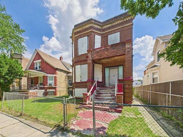 5045 W Erie St, Chicago, IL 60644 - townhome / multi-family property featuring brick siding, a fenced front yard, and a gate