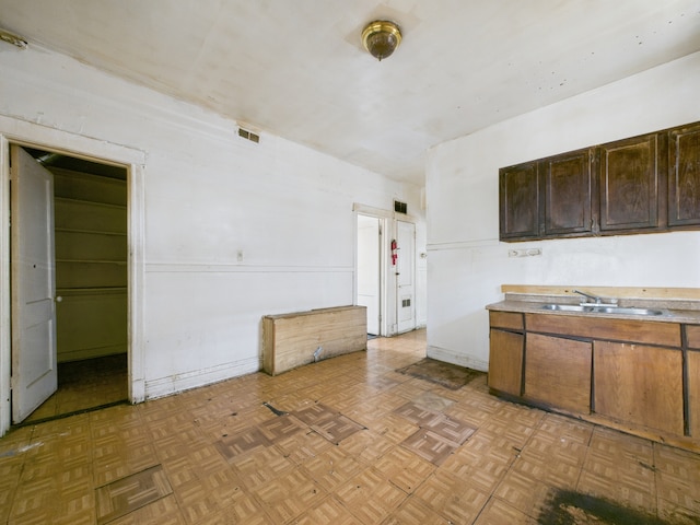 5045 W Erie St, Chicago, IL 60644 - kitchen featuring light countertops and dark brown cabinets