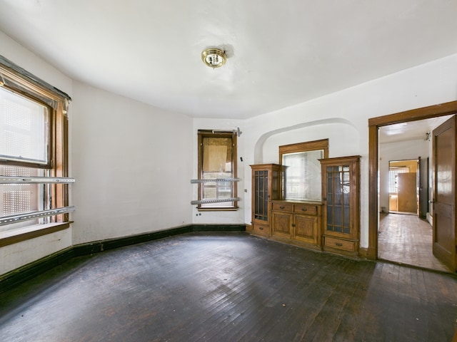 5045 W Erie St, Chicago, IL 60644 - unfurnished living room featuring hardwood / wood-style flooring and baseboards