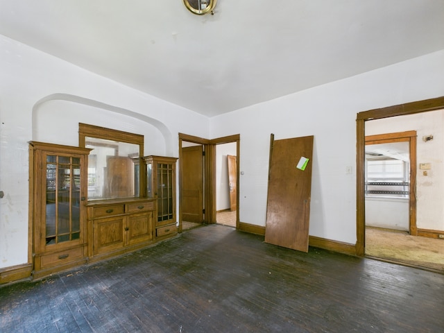 5045 W Erie St, Chicago, IL 60644 - unfurnished living room with dark wood-type flooring and baseboards