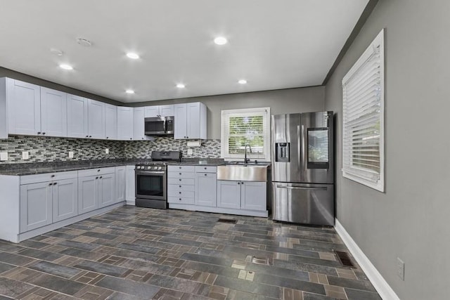 7825 Susan St, Morris, IL 60450 - kitchen with stainless steel appliances, backsplash, dark countertops, and recessed lighting