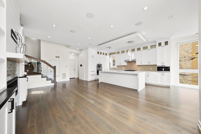 702 W Wellington Ave Unit 2N, Chicago, IL 60657 - unfurnished living room featuring wood finished floors, stairs, recessed lighting, and a fireplace