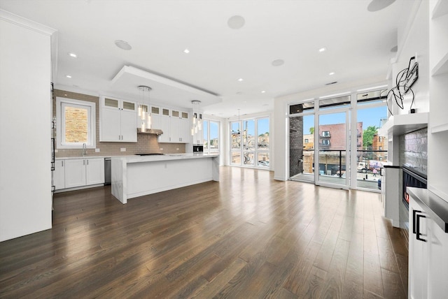 702 W Wellington Ave Unit 2N, Chicago, IL 60657 - kitchen featuring light countertops, glass insert cabinets, white cabinets, dark wood-style floors, and backsplash