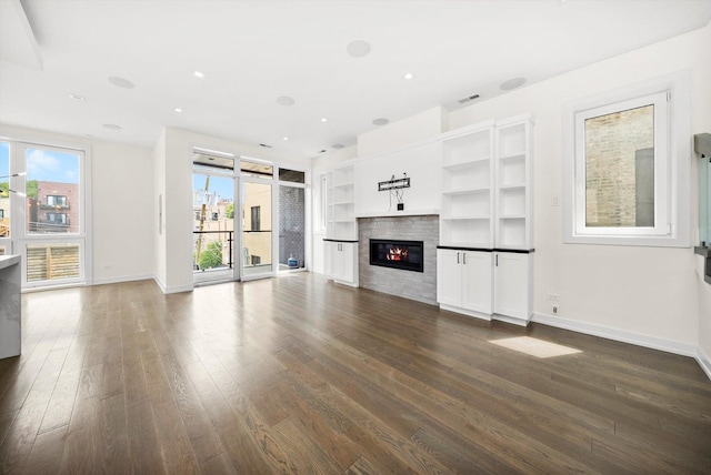 702 W Wellington Ave Unit 2N, Chicago, IL 60657 - unfurnished living room featuring dark wood-style floors, a glass covered fireplace, and recessed lighting