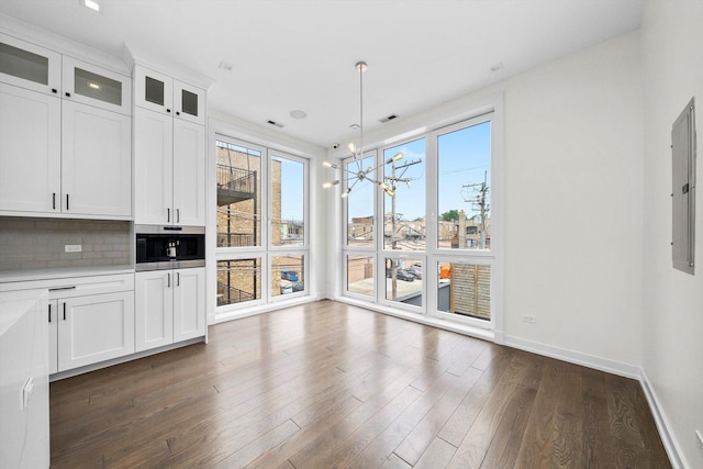 702 W Wellington Ave Unit 2N, Chicago, IL 60657 - unfurnished dining area featuring dark wood-type flooring, a chandelier, and electric panel