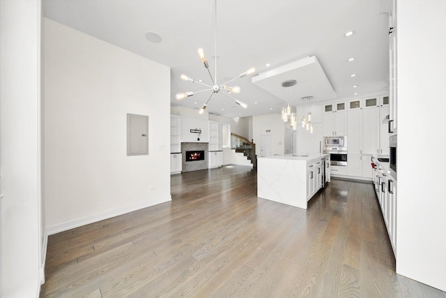 702 W Wellington Ave Unit 2N, Chicago, IL 60657 - kitchen featuring a chandelier, built in microwave, oven, open floor plan, and wood finished floors