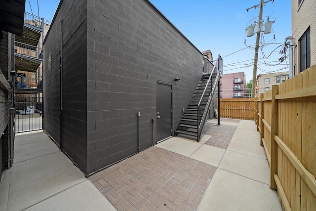 702 W Wellington Ave Unit 2N, Chicago, IL 60657 - rear view of property with stairway, concrete block siding, and a patio area