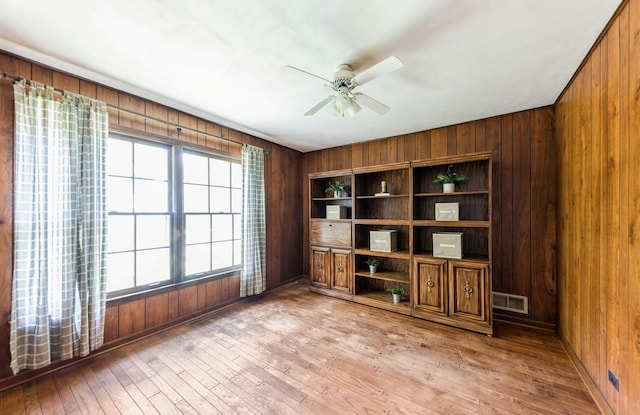 2527 Checker Rd, Long Grove, IL 60047 - unfurnished office with ceiling fan, wood walls, and light wood-style floors