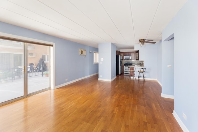1633 River St Unit 2B, Des Plaines, IL 60016 - unfurnished living room featuring wood finished floors and a ceiling fan