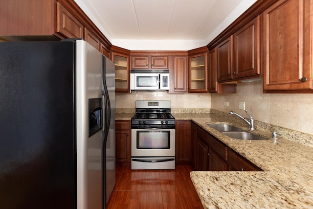 1633 River St Unit 2B, Des Plaines, IL 60016 - kitchen featuring appliances with stainless steel finishes, dark wood finished floors, light stone countertops, and glass insert cabinets