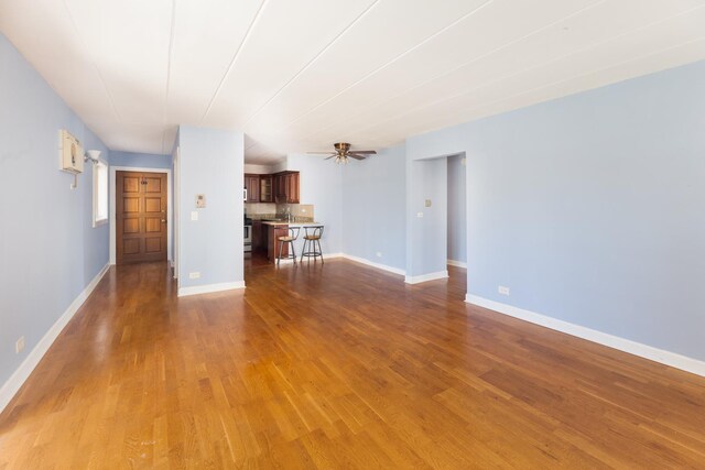 1633 River St Unit 2B, Des Plaines, IL 60016 - unfurnished living room with wood finished floors and ceiling fan
