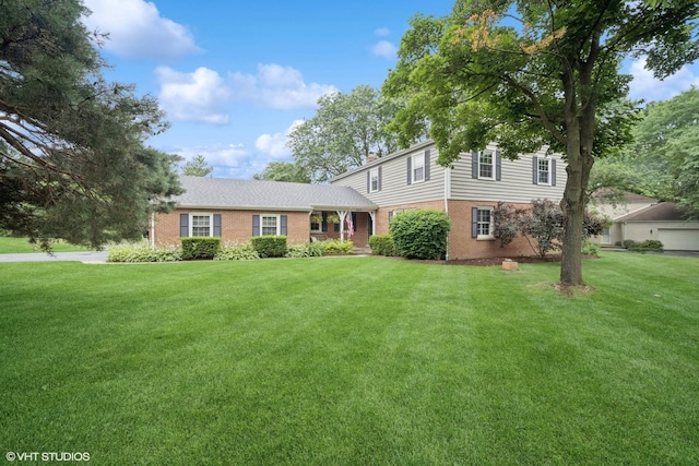 2113 Berwick St, Inverness, IL 60067 - view of front of home with brick siding, a front yard, and a chimney