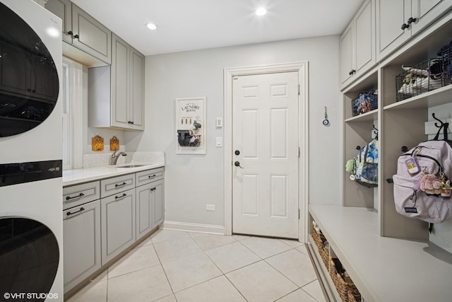 2113 Berwick St, Inverness, IL 60067 - washroom featuring stacked washer / drying machine, cabinet space, light tile patterned flooring, and recessed lighting