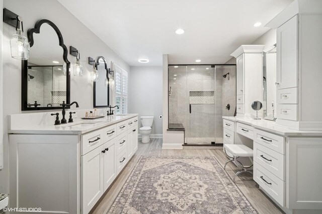 2113 Berwick St, Inverness, IL 60067 - bathroom with a stall shower, double vanity, recessed lighting, and wood finished floors