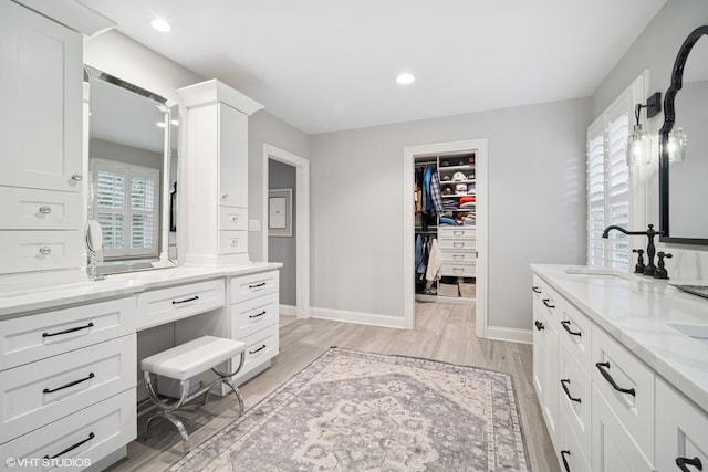 2113 Berwick St, Inverness, IL 60067 - bathroom with double vanity, wood finished floors, a spacious closet, and recessed lighting