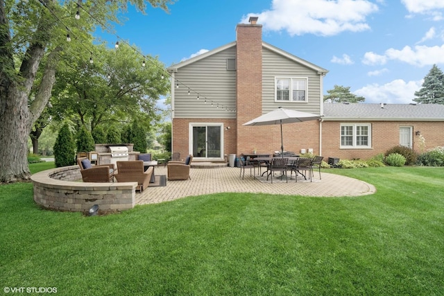 2113 Berwick St, Inverness, IL 60067 - rear view of house featuring exterior kitchen, brick siding, a patio area, and a lawn