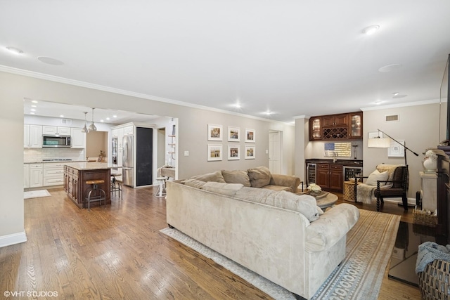 2113 Berwick St, Inverness, IL 60067 - living area featuring wood finished floors, crown molding, a dry bar, and recessed lighting
