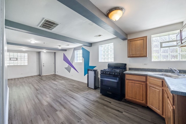 3722 S Wabash Ave, Chicago, IL 60653 - kitchen featuring black gas range oven, beamed ceiling, dark wood-style floors, brown cabinets, and open floor plan