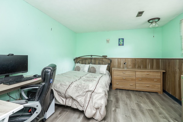7936 N Ramsgate Cir, Hanover Park, IL 60133 - bedroom featuring wood finished floors, a desk, wainscoting, and wood walls