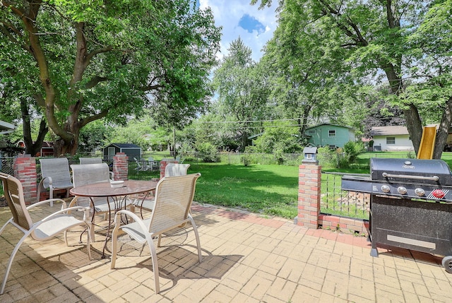 7936 N Ramsgate Cir, Hanover Park, IL 60133 - fenced backyard featuring a grill, a storage shed, a patio area, outdoor dining area, and view of wooded area