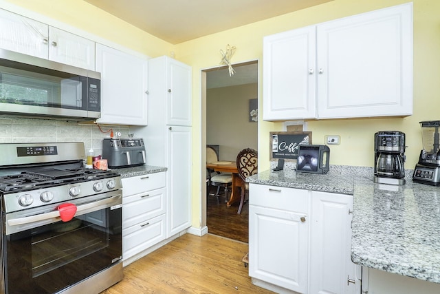 7936 N Ramsgate Cir, Hanover Park, IL 60133 - kitchen with appliances with stainless steel finishes, light wood-style flooring, and white cabinetry