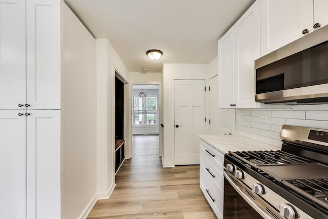 1329 Neskola Ct, Naperville, IL 60564 - kitchen with appliances with stainless steel finishes, light wood finished floors, decorative backsplash, white cabinetry, and light stone counters