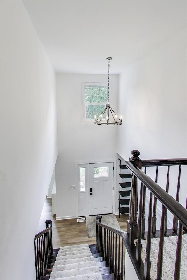 1329 Neskola Ct, Naperville, IL 60564 - entryway featuring a chandelier, healthy amount of natural light, wood finished floors, stairway, and a towering ceiling