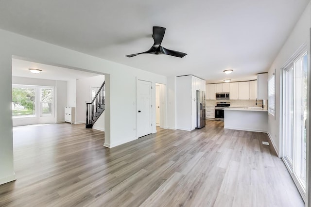 1329 Neskola Ct, Naperville, IL 60564 - unfurnished living room featuring stairs, light wood-type flooring, and ceiling fan