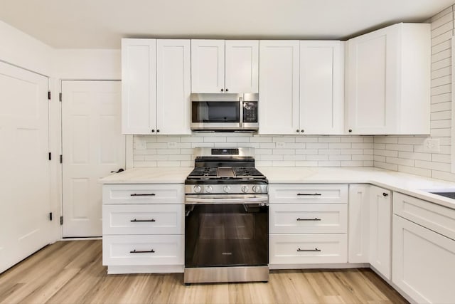 1329 Neskola Ct, Naperville, IL 60564 - kitchen featuring stainless steel appliances, white cabinets, light countertops, and light wood-type flooring