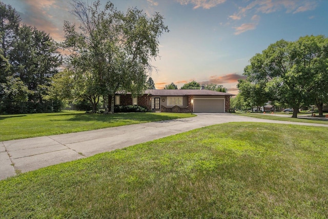 1619 Arnold Ave, Rockford, IL 61108 - ranch-style house with an attached garage, driveway, and a lawn