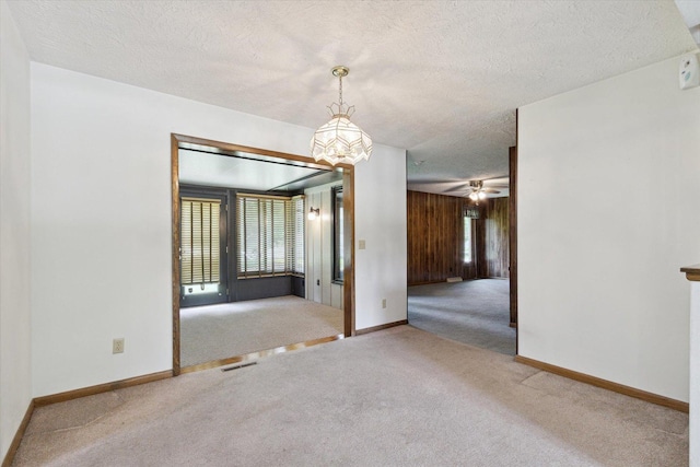 1619 Arnold Ave, Rockford, IL 61108 - carpeted spare room featuring a textured ceiling and a chandelier